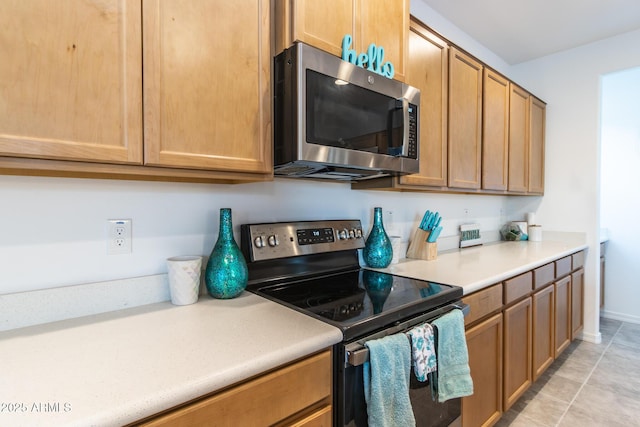 kitchen featuring stainless steel appliances and light countertops