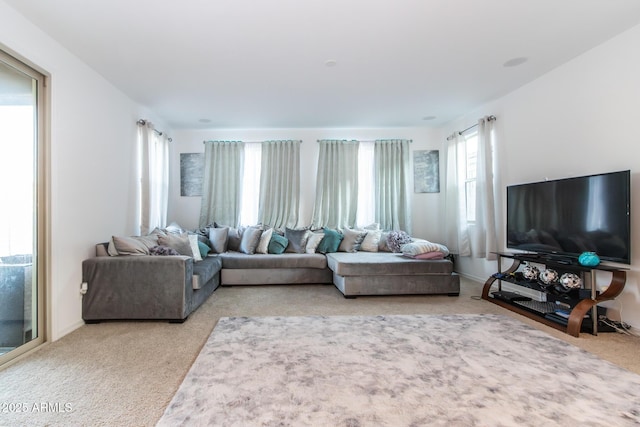 living area featuring light carpet