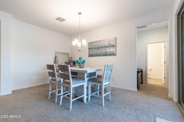 dining area with a chandelier, carpet flooring, and baseboards