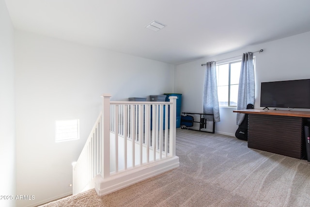 staircase featuring carpet flooring and baseboards