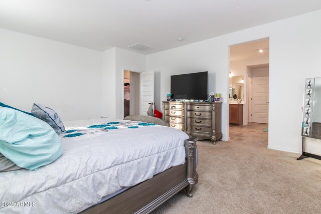 bedroom with light carpet and baseboards