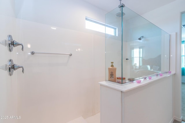 bathroom featuring a walk in shower and healthy amount of natural light