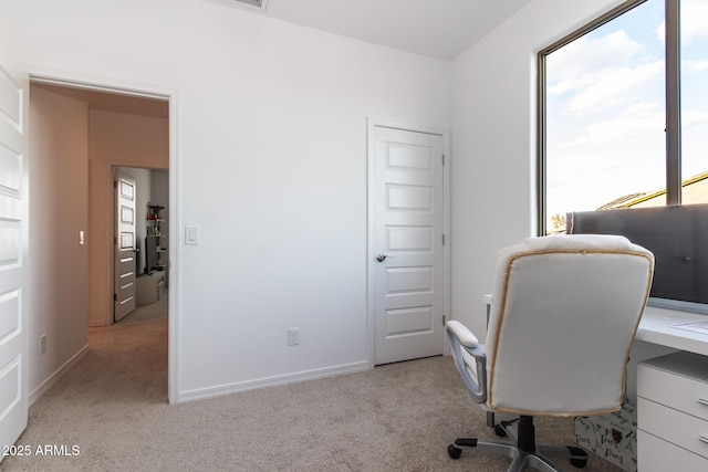 office area with carpet floors, healthy amount of natural light, and baseboards