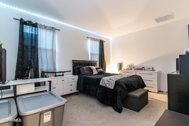 bedroom featuring light carpet