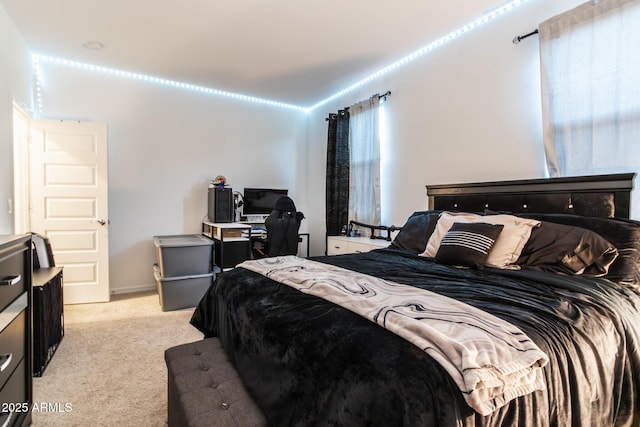 bedroom featuring light carpet