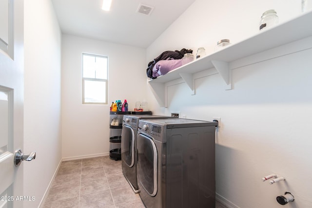 laundry area with independent washer and dryer and baseboards