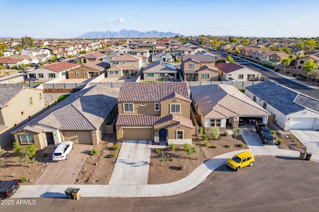 aerial view of residential area featuring mountains