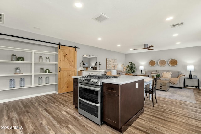 4840 E Sunnyside Dr, Scottsdale, AZ 85254 - kitchen with dark brown cabinets, visible vents, light wood-style floors, and range with two ovens