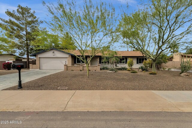 4840 E Sunnyside Dr, Scottsdale, AZ 85254 - ranch-style home with a garage, driveway, brick siding, and fence