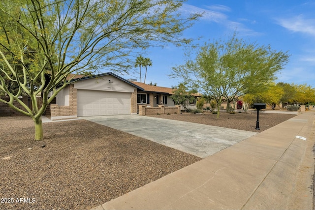 4840 E Sunnyside Dr, Scottsdale, AZ 85254 - ranch-style house with an attached garage, brick siding, and concrete driveway