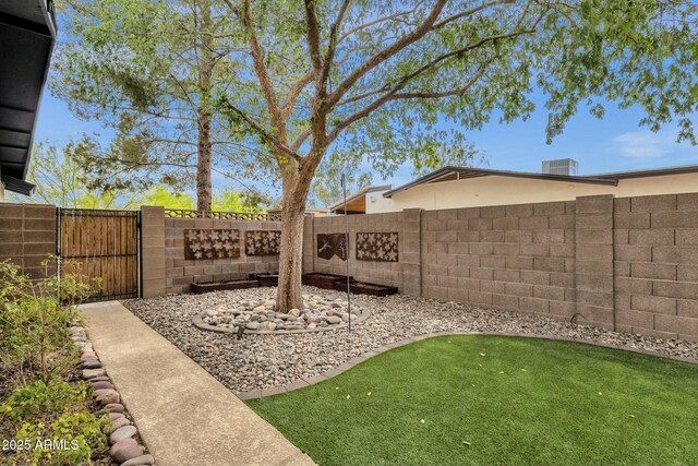 4840 E Sunnyside Dr, Scottsdale, AZ 85254 - view of yard with a fenced backyard, a gate, and central AC unit