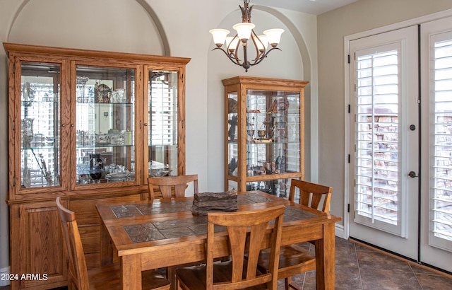 dining area with french doors and a notable chandelier