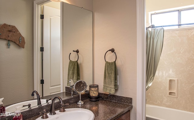bathroom with washtub / shower combination and vanity