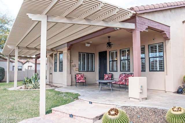 view of patio / terrace with ceiling fan and a pergola
