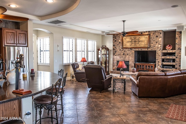 living room featuring visible vents, baseboards, ceiling fan, recessed lighting, and arched walkways