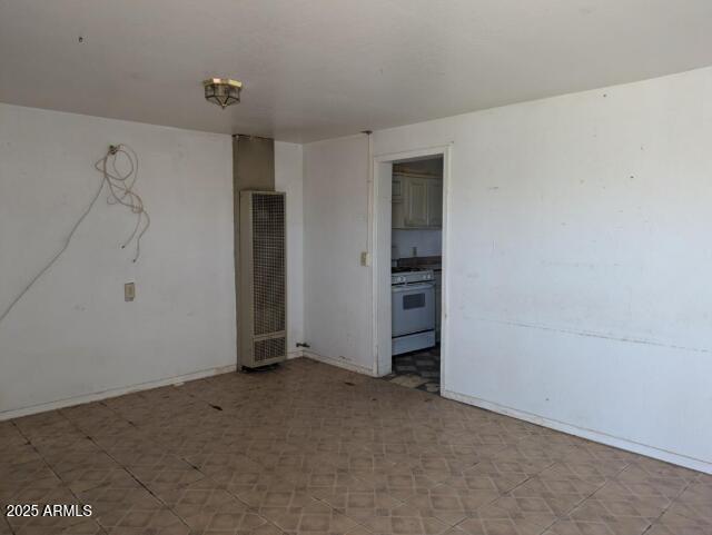 2602 E Jones Ave, Phoenix, AZ 85040 - spare room featuring tile patterned floors and a heating unit