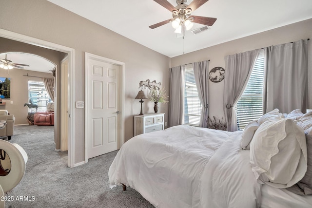 bedroom with carpet, visible vents, vaulted ceiling, and baseboards