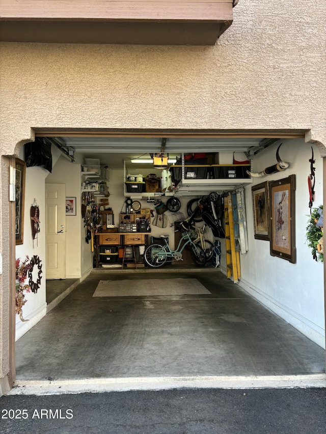 garage featuring a workshop area and baseboards