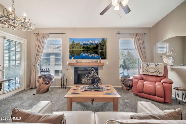 carpeted living room featuring plenty of natural light, a glass covered fireplace, and baseboards