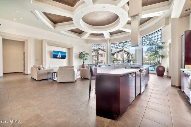 kitchen featuring range, a high ceiling, a breakfast bar, and crown molding