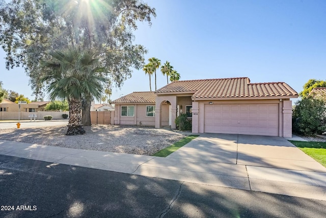 mediterranean / spanish-style home with a garage