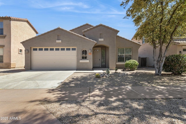 3013 W Via De Pedro Miguel, Phoenix, AZ 85086 - mediterranean / spanish-style home with stucco siding, concrete driveway, an attached garage, and a tiled roof