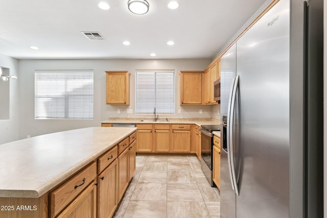 3013 W Via De Pedro Miguel, Phoenix, AZ 85086 - kitchen featuring appliances with stainless steel finishes, light countertops, recessed lighting, a center island, and light brown cabinets