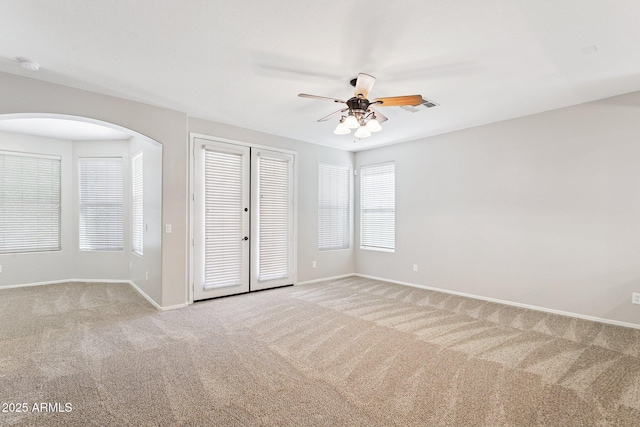 3013 W Via De Pedro Miguel, Phoenix, AZ 85086 - empty room with a ceiling fan, light colored carpet, and arched walkways
