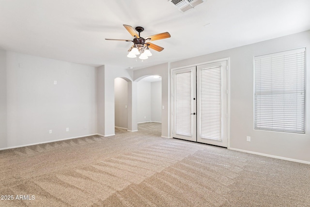 3013 W Via De Pedro Miguel, Phoenix, AZ 85086 - unfurnished room with arched walkways, light carpet, a ceiling fan, and french doors