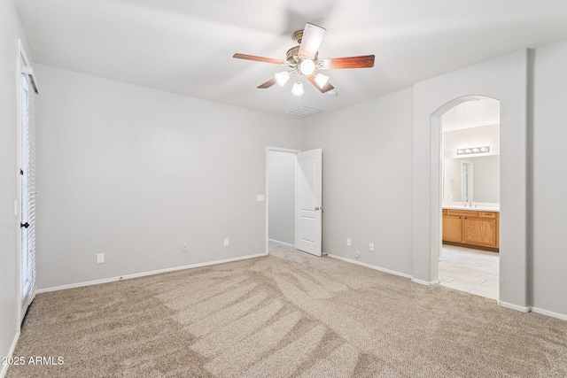 3013 W Via De Pedro Miguel, Phoenix, AZ 85086 - unfurnished bedroom with light carpet, arched walkways, connected bathroom, and ceiling fan