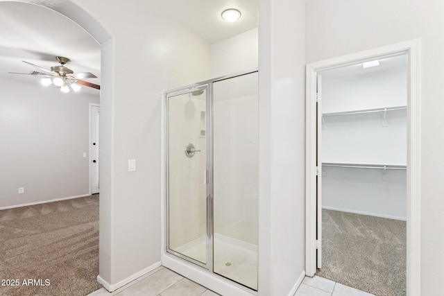 3013 W Via De Pedro Miguel, Phoenix, AZ 85086 - bathroom featuring a shower stall, a ceiling fan, a walk in closet, and tile patterned floors