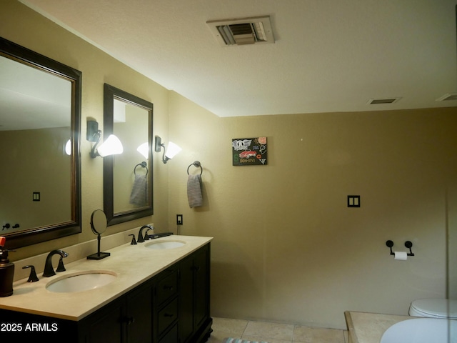 bathroom featuring tile patterned floors, toilet, and vanity