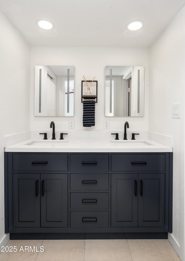 bathroom featuring tile patterned flooring and vanity