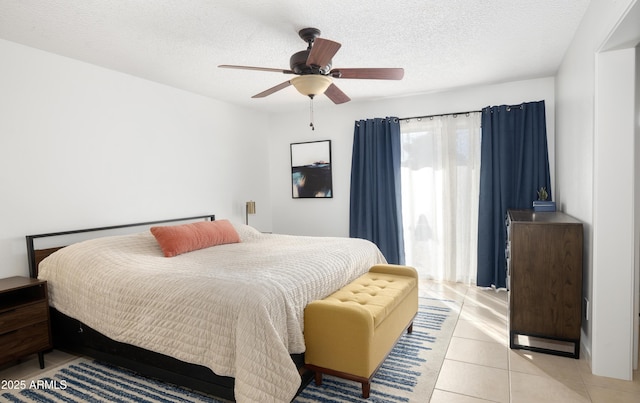 bedroom with a textured ceiling, ceiling fan, and light tile patterned flooring