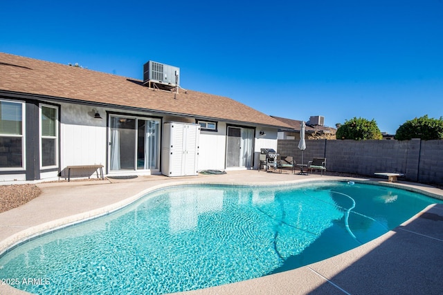 view of pool with central AC and a patio