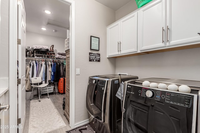 laundry room with washer and dryer, recessed lighting, and cabinet space