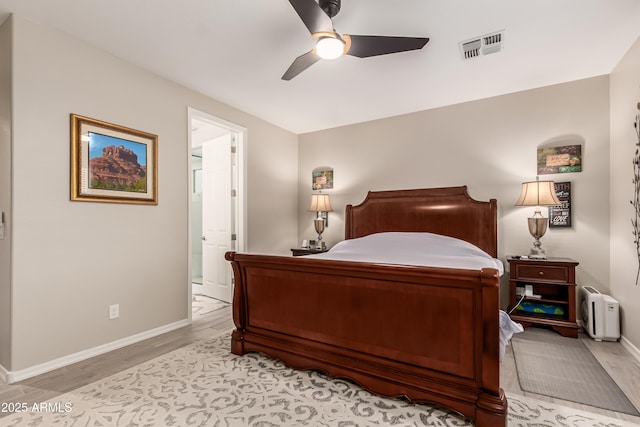 bedroom with light wood-style floors, baseboards, a ceiling fan, and visible vents
