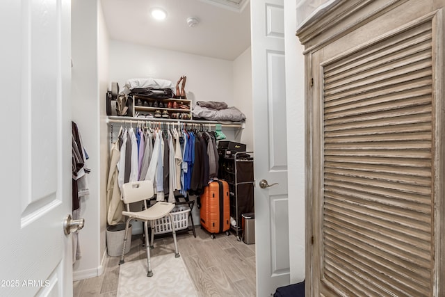 walk in closet featuring wood finished floors