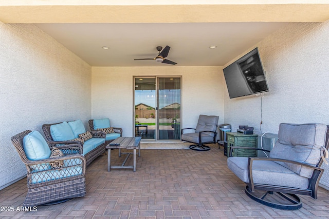 view of patio with a ceiling fan and outdoor lounge area