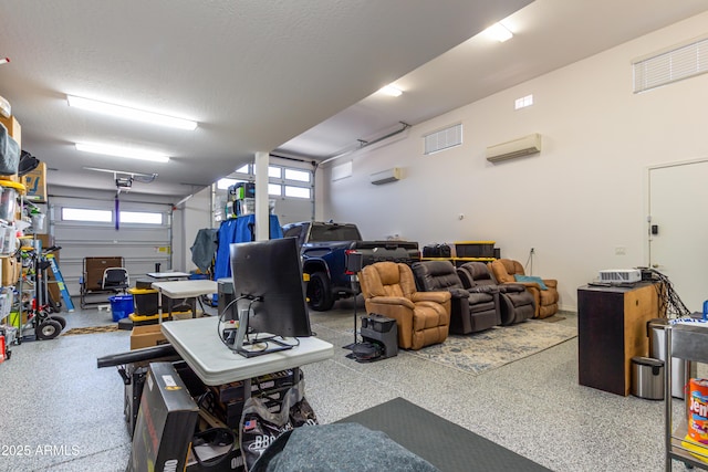 garage featuring a garage door opener, a wall mounted AC, and visible vents