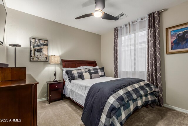 bedroom featuring baseboards, visible vents, ceiling fan, and light colored carpet