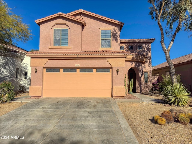 mediterranean / spanish-style house with a garage