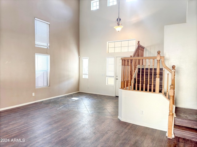 tiled foyer entrance with a towering ceiling