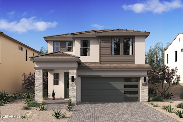 view of front of house featuring a garage, stone siding, decorative driveway, and stucco siding