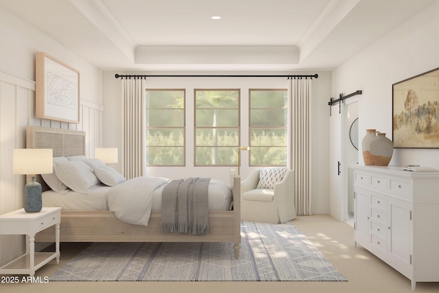 bedroom featuring light carpet, a barn door, a tray ceiling, and ornamental molding