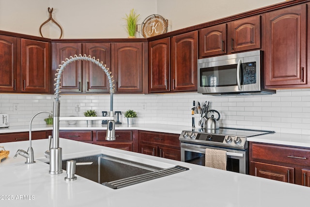 2239 N Calvin, Mesa, AZ 85207 - kitchen with appliances with stainless steel finishes, light countertops, a sink, and dark brown cabinets
