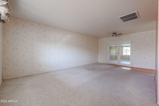 spare room with carpet flooring and ceiling fan