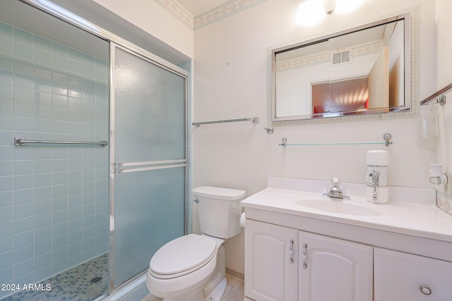 bathroom featuring vanity, a shower with door, tile patterned flooring, toilet, and ornamental molding