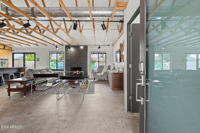 living room featuring a fireplace and concrete floors