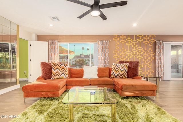 living room with ceiling fan, a healthy amount of sunlight, and light wood-type flooring